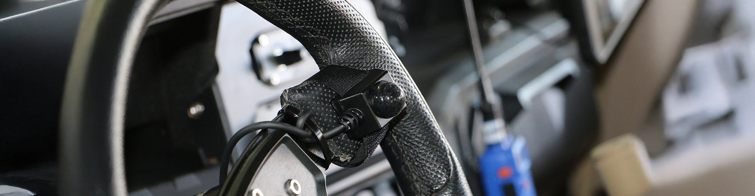 Intercom and handheld radio PTT buttons—Velcro‑mount PTTs (coil and straight), hole‑mount steering‑wheel PTTs, quick‑disconnect PTTs, rocker switch buttons, foot‑pedal PTT, belts‑station PTT, extension cables, and intercom‑to‑car harness adapters.