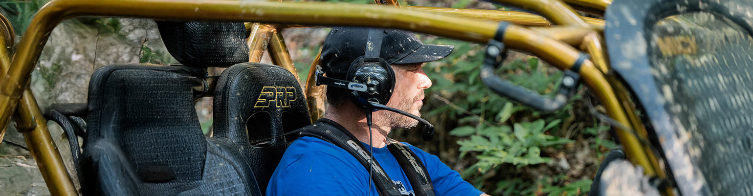 Noise‑canceling intercom headsets with boom mic, available in BTH and OTH styles for race team communication