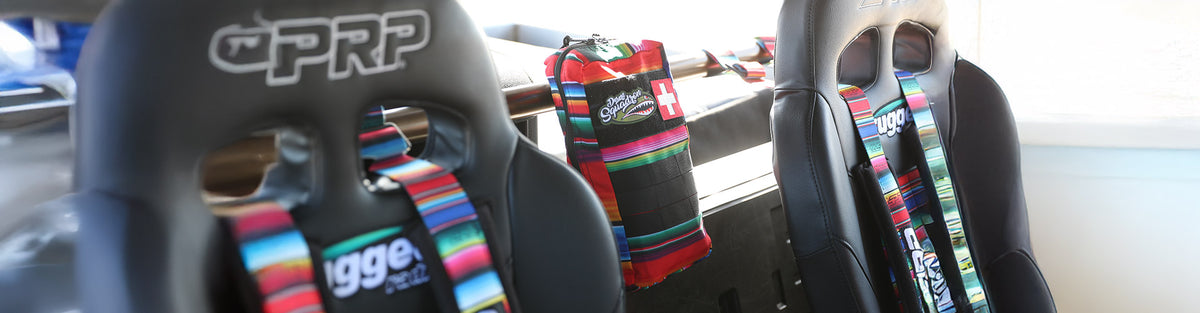 Race safety gear including neck restraints, first‑aid kits, and catheter supplies