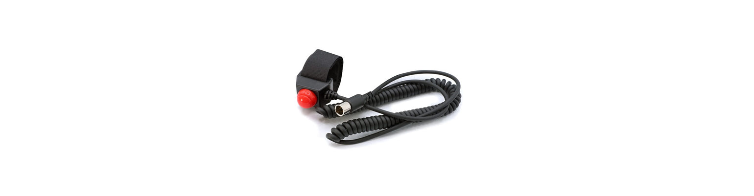 Rugged Radios Collection car‑harness push‑to‑talk button with red PTT, coiled cord, rugged connector, designed for steering‑wheel mounting in race vehicles